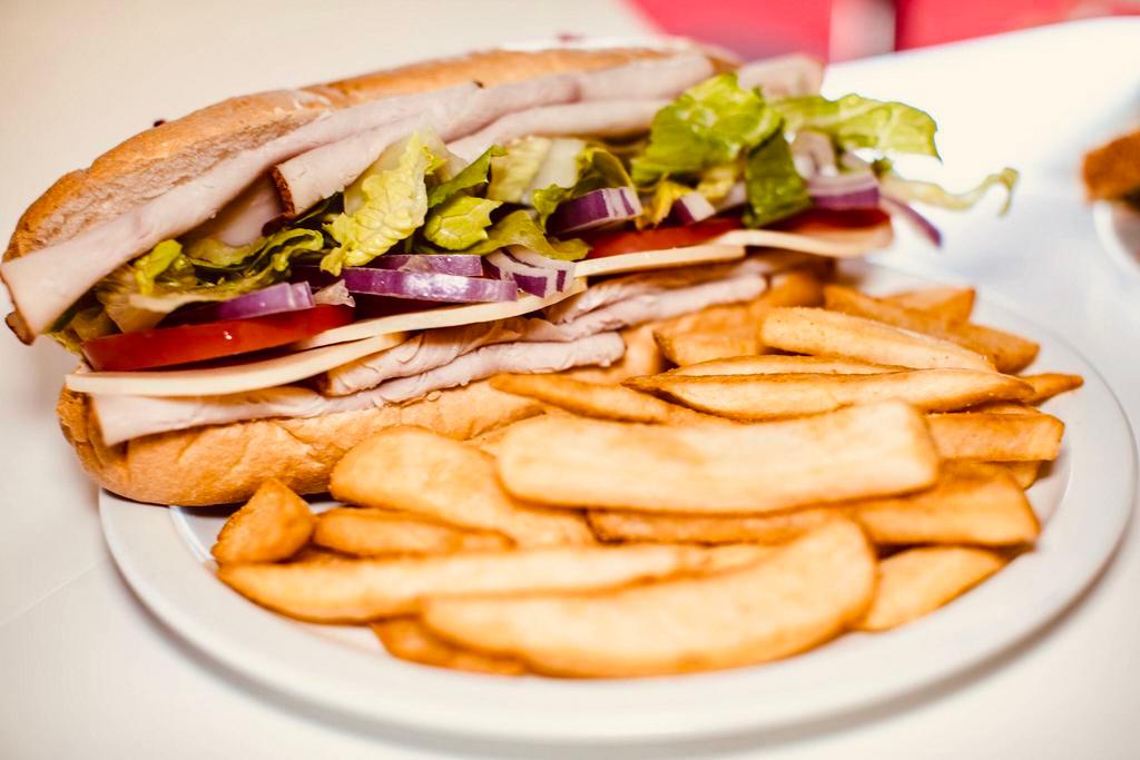 Turkey Breast & Provolone Sandwich · With mayonnaise and mustard, sliced turkey breast, lettuce, tomatoes, red onions, and Provolone cheese. Served with your choice of steak fries or house salad.

