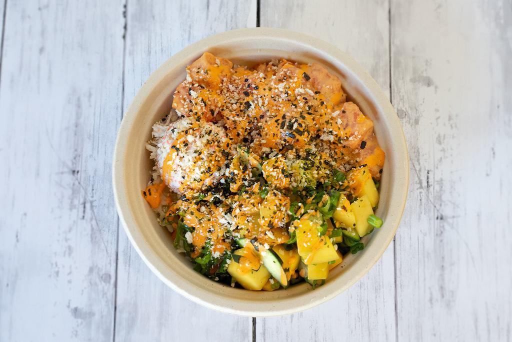 Spicy Miso Mango Salmon Bowl · This refreshing combination features our spicy miso salmon mixed with mangoes, green onions, and cucumbers. Topped with furikake, crunchy panko, and finished with a drizzle of sriracha aioli. Served with crab salad and seaweed salad.
