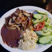 Bistec Encebollado · Grilled steak topped with onions served w/ rice, beans and salad
