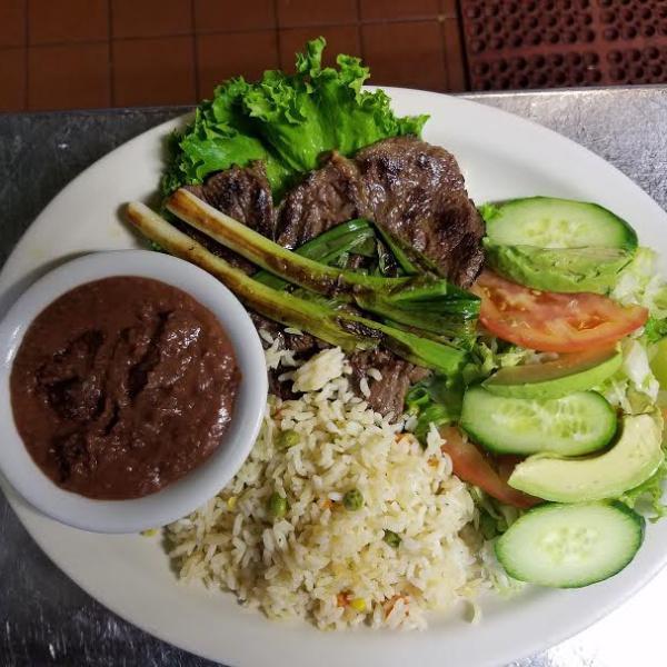 Carne Asada · Grilled steak served w/ rice, beans and salad