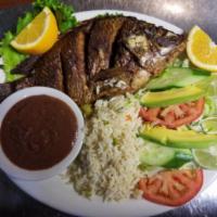 Mojarra Frita · Fried whole fish served w/ rice and cabbage salad