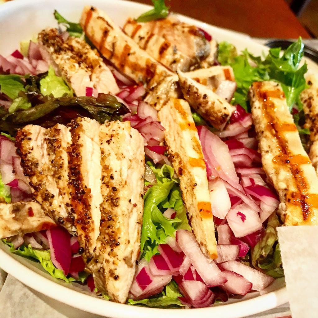 Chicken Caesar Salad · Organic harvest lettuce blend with grilled chicken, red onion & pretzel croutons, with Caesar dressing.
