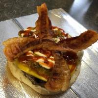 Bacon Cheese Burger · A burger served in a steamed bun topped with American cheese and bacon. 