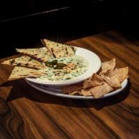 Spinach Artichoke Queso · A rich blend of creamy cheese, spinach, artichoke hearts, jalapenos and onions served with t...