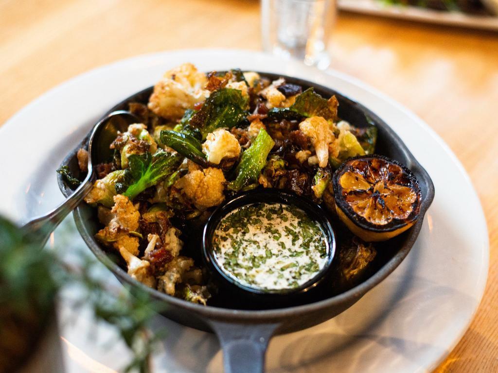 Fried Brussels Sprouts and Cauliflower · Flash-fried with bacon, blue cheese crumbles, miso-tahini, smoked sea salt, chipotle-balsamic drizzle, grilled lemon. Gluten-free. 