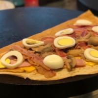 The Breakfast Crepe · American cheese bacon Canadian bacon hard boiled egg and mushrooms.