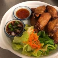 Chicken Wings · Thai style deep-fried chicken wings, served with sweet and sour sauce.