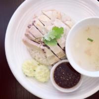 Hainan Chicken Over Rice · Steamed chicken served over ginger rice with our sweet and spicy sauce.