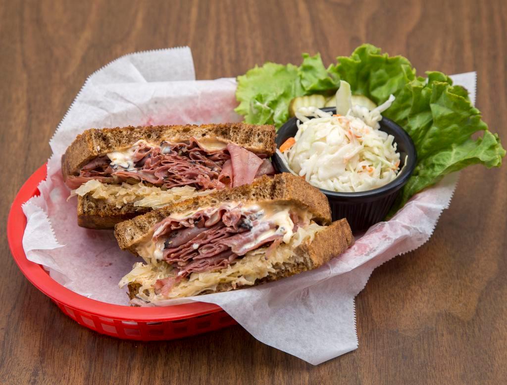 Pastrami Reuben · Hot pastrami on grilled rye with 1000 Island dressing, sauerkraut and melted Swiss cheese. Served with a side of fries, onion rings or slaw. 