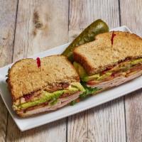 Club Sandwich · Ham, turkey, crispy bacon, lettuce, tomato, avocado and mayo on 9-grain bread.