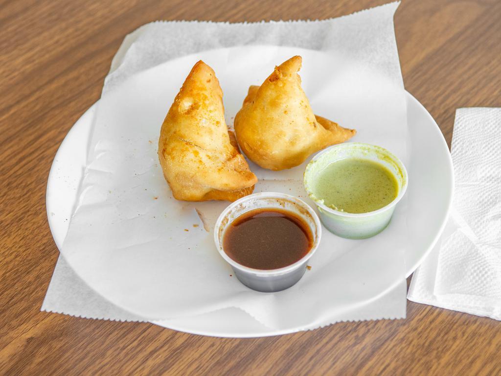 2 Piece Samosa · A triangular savory pastry deep fried, containing spiced potatoes. 