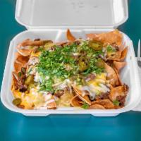 Super Nacho · Tortilla chips topped with nacho cheese, beans, Monterey jack cheese, cilantro, chopped onio...