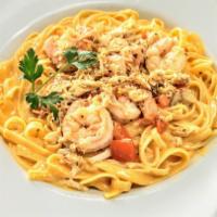 Seafood Pasta · Crab meat, shrimp, tomato, spaghetti in a cream sauce with garlic bread
