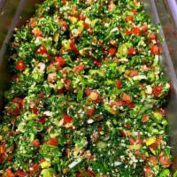 Tabbouleh Salad · Finely chopped parsley, tomatoes, mint, bulgur and seasoned with lemon and olive oil.
