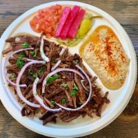 Beef Shawarma Plate · Served with rice, hummus, salad topped with onions and drizzled with tahini sauce. pita brea...