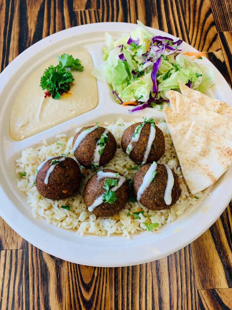 Falafel Plate · Served with Hummus, Salad, Rice falafels drizzled with tahini and pita bread