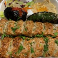 Chicken Lule Kabob · Served with rice,  salad, hummus, onions, grilled tomato, grilled jalapeno and pita bread.