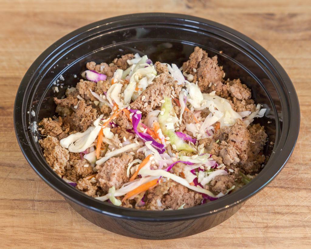 Turkey Eggroll Bowl · Lean ground turkey seasoned with sesame oil served over rice, topped with carrots, mixed cabbage, microgreens, and crispy wontons, served with a side of sweet chili sauce. 