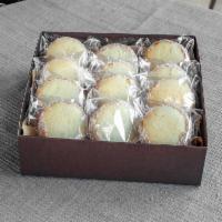 Dozen Alfajores  · Cornstarch shortbread cookies filled dulce de leche, with coconut on the sides.