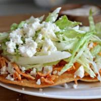 Tostadas · Crispy corn tortilla topped with protein, cheese, lettuce, refried beans and sour cream.