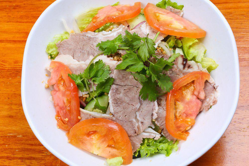 Grilled Pork Salad 烤猪肉片沙拉 · Fresh daikon radish, carrots, iceberg lettuce, cucumber, tomatoes, mint leaves, and red onions. Tossed in special fish lemon vinaigrette.