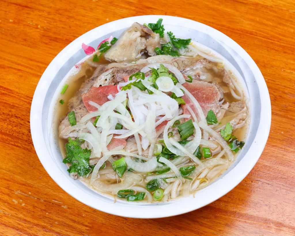 Pho Xe Lua #1 火车头牛肉粉 · Rare thin beef, brisket beef, tripe, and tendon. Rice noodle beef soup base. Served with basil lemon sprouts.
