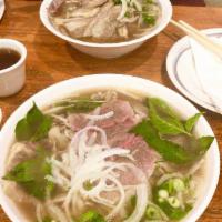 Pho Fresh Rare Thin Beef #2 生肉河粉 · Fresh rare thin beef. Rice noodle beef soup base. Served with basil lemon sprouts.