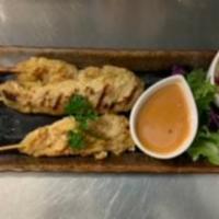 Chicken Satay  · Chicken tender on skewers marinated in thai herbs serwed with peanut sauce and cucumber sauce.
