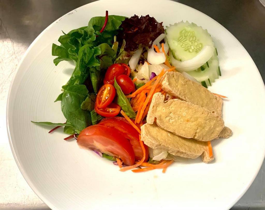 Thai Salad · A variety of fresh garden greens with tomatoes, onion, carrots, cucumbers and fried tofu. Served with homemade peanut or vinaigrette.
