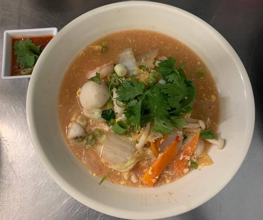 Thai Sukiyaki · Thai style noodle soup with mix seafood, napa, scallions, Chinese celery, egg, glass noodle, sesame seed. Served with sukiyaki sauce. Spicy.