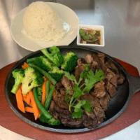 Crying Tiger  · Grilled marinated ribeye steak, served with sticky rice and traditional thai spicy sauce on ...