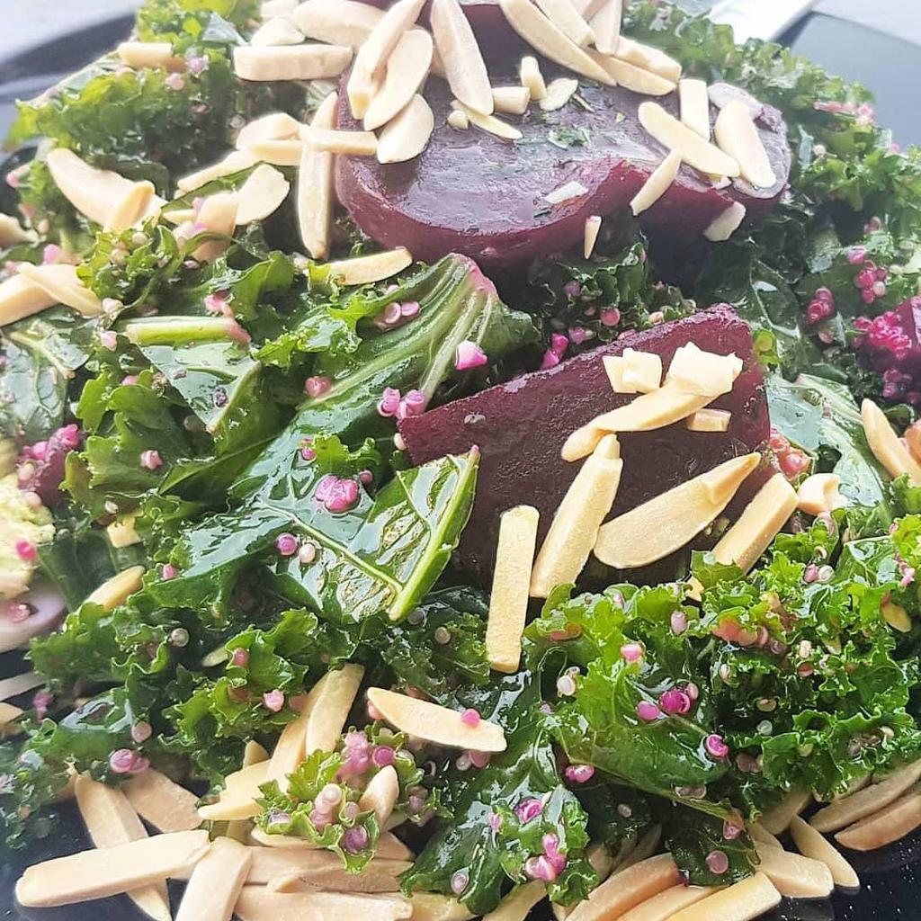 Kale and Quinoa Salad · Kale and quinoa salad with roasted red beets, dried raisins, roasted sliced almonds, deviled eggs, Parmesan cheese and light vinaigrette.
