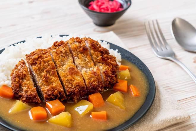 Pork Katsu Curry · Freshly battered pork with panko fried to a crisp perfection served with curry, cabbage, and red pickles.