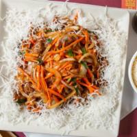 Mongolian Beef · Sliced beef, carrots, yellow and green onions sauteed in brown sauce spread on a bed of frie...