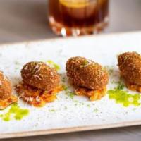 Croquetas de Guineo  · Plantain croquette, sundried tomato, slaw, lime zest and greated manchego cheese. Vegetarian. 