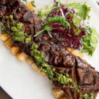 Churrasco Plate · Grilled skirt steak, yucca fries, Caribbean mojo, chimichurri.