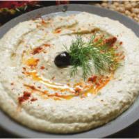 Hummus · A rich chickpeas and tahini paste, prepared with milk, garlic, lemon juice, and olive oil.