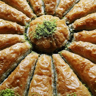 Baklava and Kinds · Sweet pastry made of extremely thin sheets of filo dough layered with chopped nuts and honey syrup. Baked with butter and cut into diamond shapes.