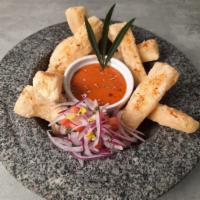 Yuca Frita , huacatay y rocoto  sauces  · Fried Yucca to dip in a delicious sauce of roasted peppers with rocoto and mint black sauce 