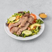 Steak Salad · Marinated flank steak served over an assortment of greens, corn salsa, avocado, tomato and c...