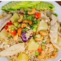Pineapple Fried Rice · Jasmine rice, chicken, egg, green and red onion, tomato, peas, cucumber, carrot, and cashew ...
