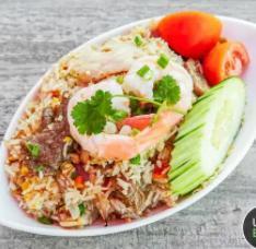 Thai-Fried Rice · Jasmine rice with chicken, egg, green and red onion, carrot, tomato, peas, and cucumber.