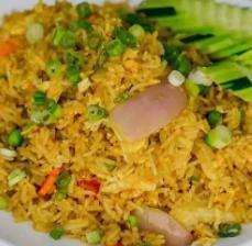 Curry Fried Rice · Jasmine rice, curry, chicken, egg, green and red onion, tomato, carrot, peas, and cucumber.