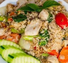 Thai Basil Fried Rice · Rice, chicken, egg, green and red onion, carrot, bell pepper, broccoli, mushroom, Thai basil, cucumber, and tomato.