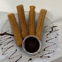 Churro sticks · Four perfectly bake churro sticks sprinkled with cinnamon and sugar with chocolate and caram...