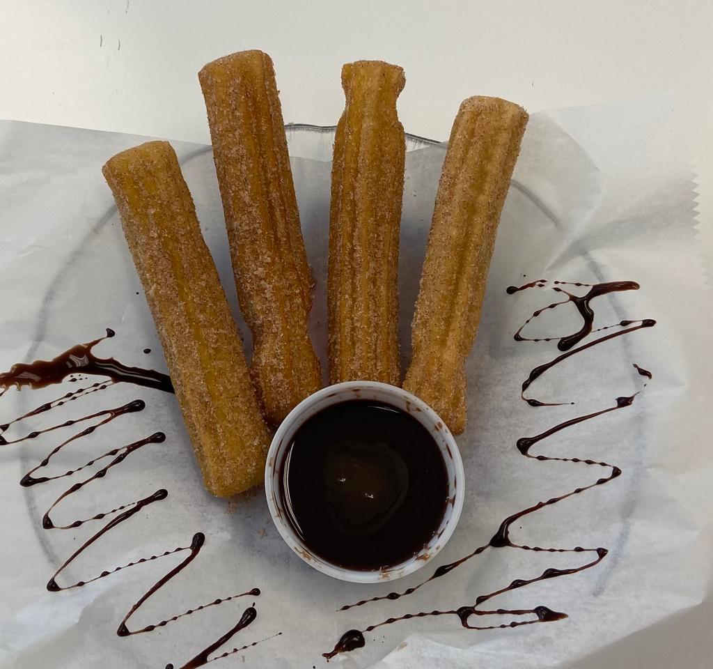 Churro sticks · Four perfectly bake churro sticks sprinkled with cinnamon and sugar with chocolate and caramel dipping sauce.