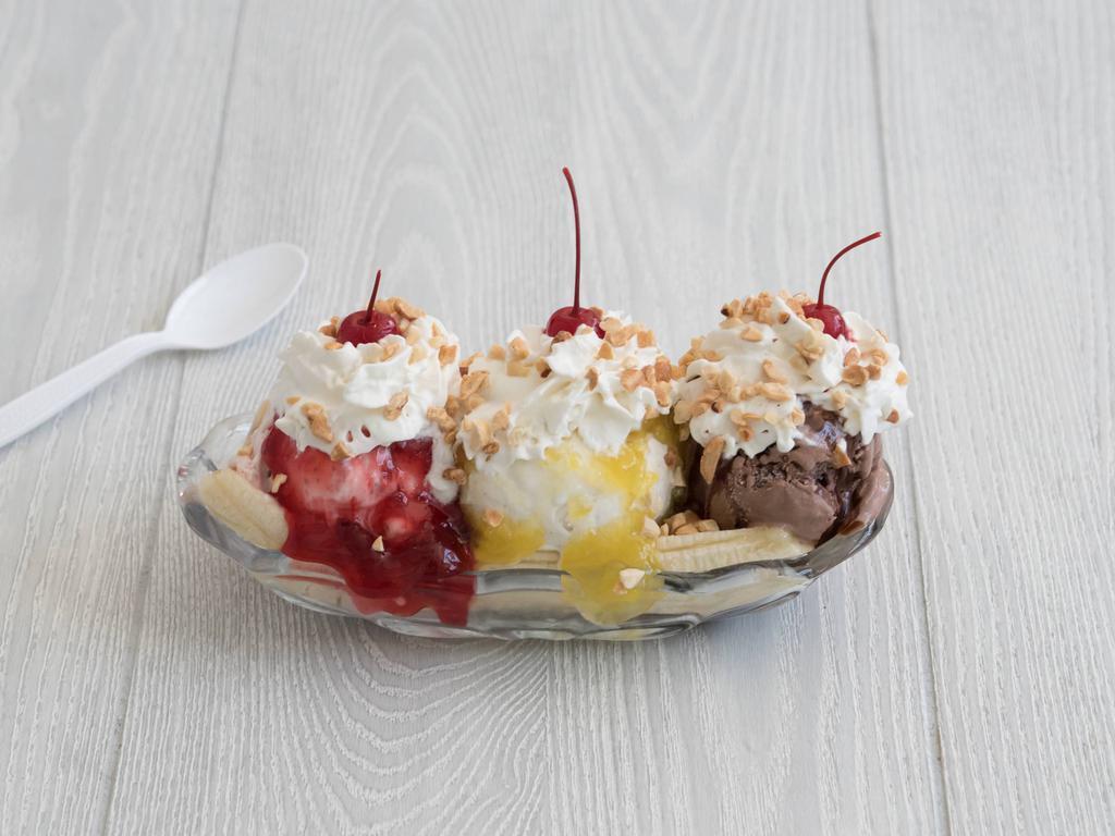 Banana Split · Traditional. 1 scoop each of chocolate vanilla and strawberry ice cream nestled between 2 banana
halves. Drizzled in chocolate syrup strawberry topping and pineapple topping. Topped with whipped cream, cherry and dried walnuts.