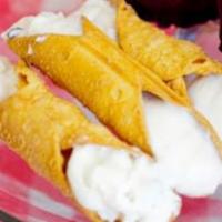 Cannoli · An Italian pistachio pastry shell filled with chocolate chips and a sweet creamy filling.