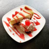 New York Style Cheesecake · Classic New York style cheesecake, drizzled in raspberry sauce.