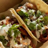 Spicy Pork Tacos · spicy pork, chopped kimchi, diced onions, cilantro, spicy K-BBQ sauce and our house korean c...